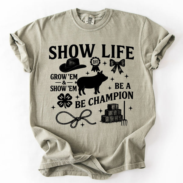 Beige t-shirt with black livestock show life graphic design and text on a white background