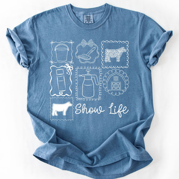 Show Life coquette graphic tee with livestock show icons on blue Comfort Colors shirt