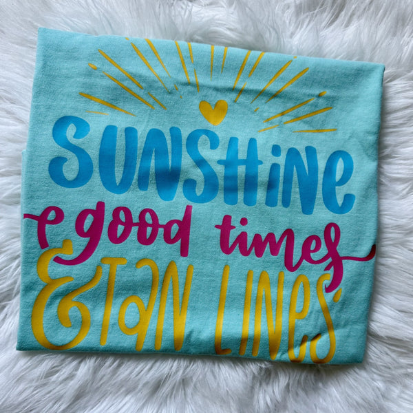 Sunshine Good Times and Tan Lines graphic tee on mint blue shirt with colorful summer beach design