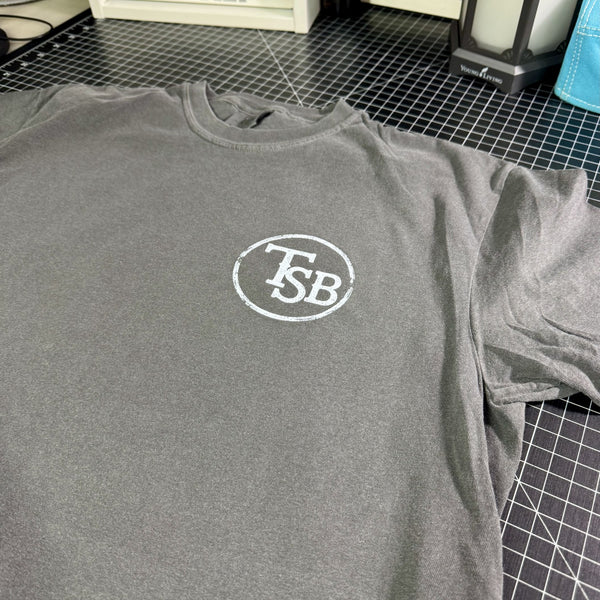 Pepper Comfort Colors T-shirt with white distressed TSB cattle brand logo on the front chest