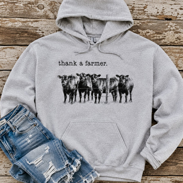 Ash gray Thank a Farmer hoodie with black cattle ranch graphic styled with distressed denim jeans