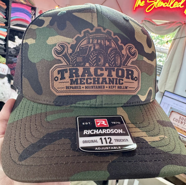 Tractor mechanic leather patch on green camo Richardson 112 trucker hat with tractor and wrench design
