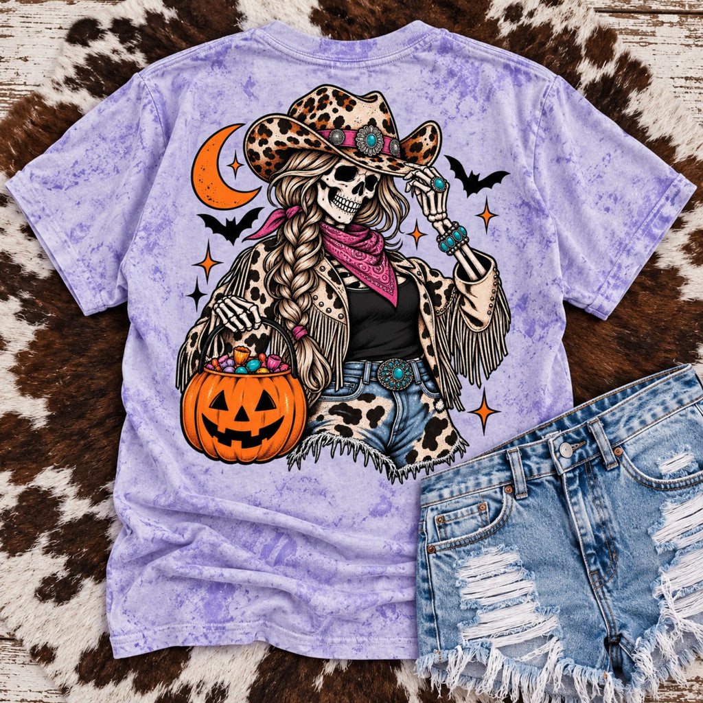 Comfort Colors Amethyst Color Blast cowgirl Halloween tee with skeleton cowgirl leopard hat turquoise accents and pumpkin candy bucket
