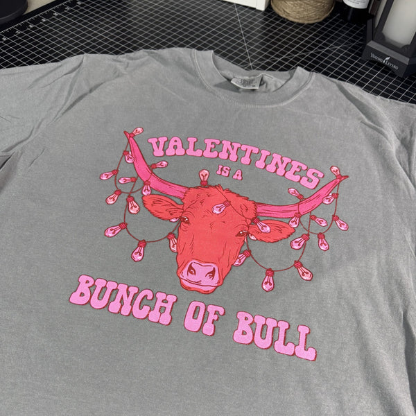 Valentine’s Is a Bunch of Bull graphic tee on gray Comfort Colors shirt with pink western bull and Valentine lights design