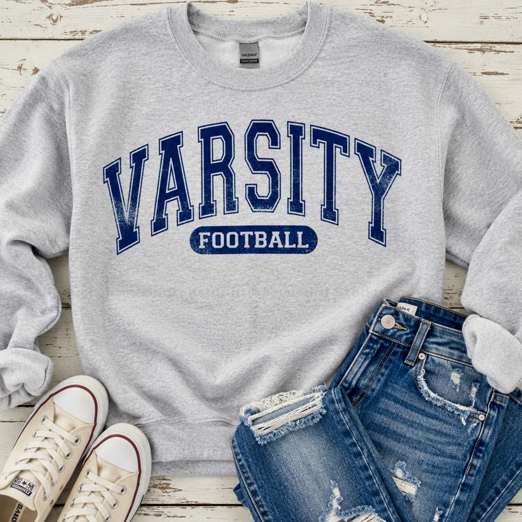Ash gray Varsity Football sweatshirt with distressed navy lettering styled with ripped denim shorts