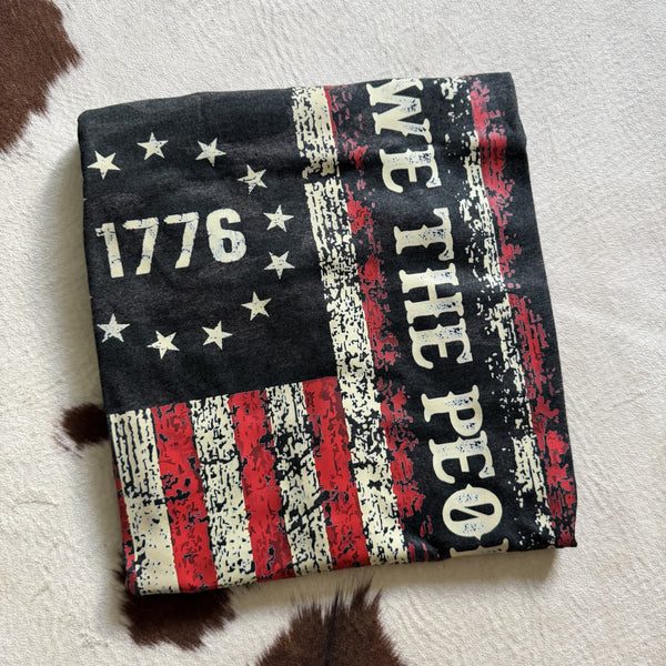 We The People 1776 graphic tee featuring distressed American flag design on black camo shirt