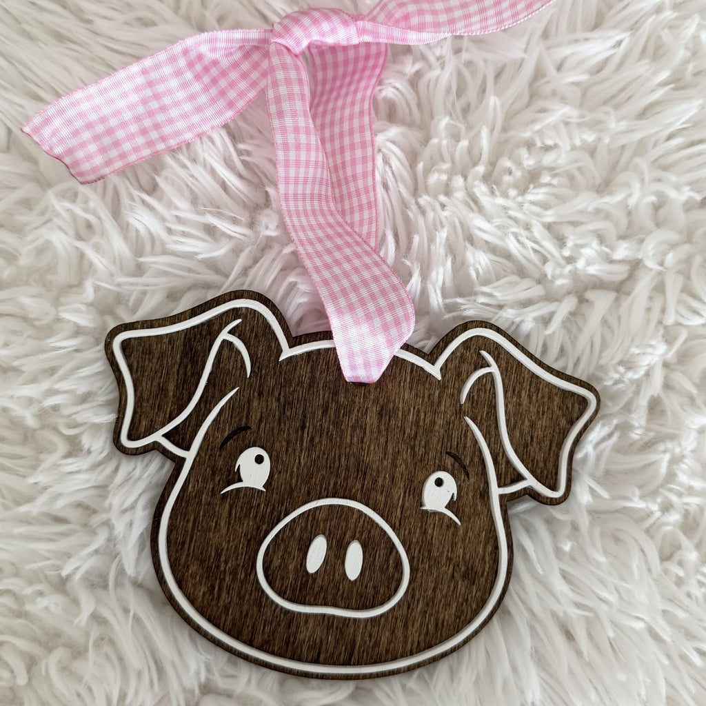 Handmade wooden pig Christmas ornament with pink gingham ribbon and layered white details