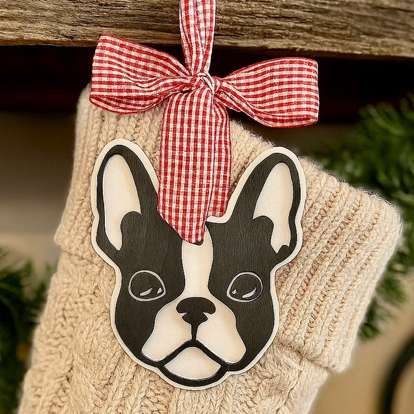 Decorative stocking with a hanging Boston Terrier face ornament and red checkered bow