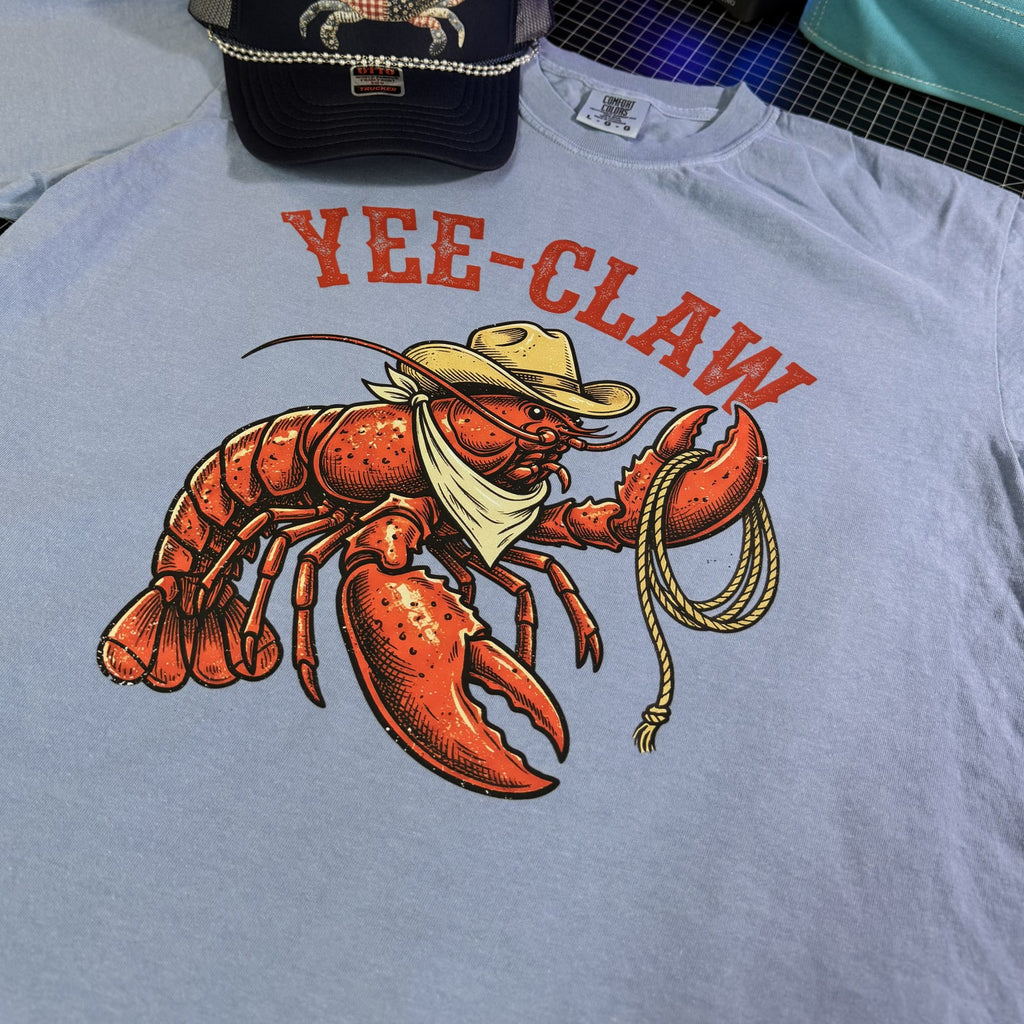 Blue t-shirt with a lobster graphic and 'YEE-CLAW' text on Comfort Colors brand tee